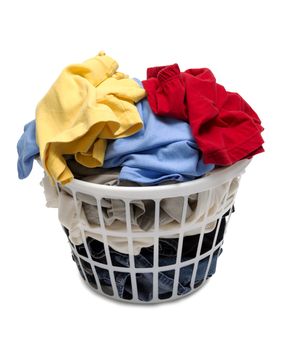 Pile of colorful dirty laundry in white basket isolated on white background