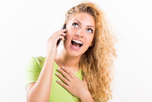 Portrait of a young smiling woman using a cellphone.