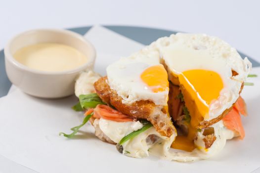 Close up scene of grilled sandwich with bacon and fried egg