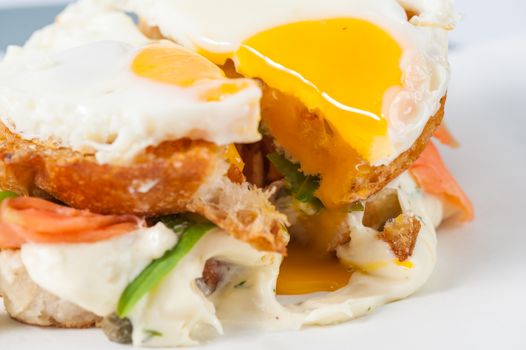 Close up scene of grilled sandwich with bacon and fried egg