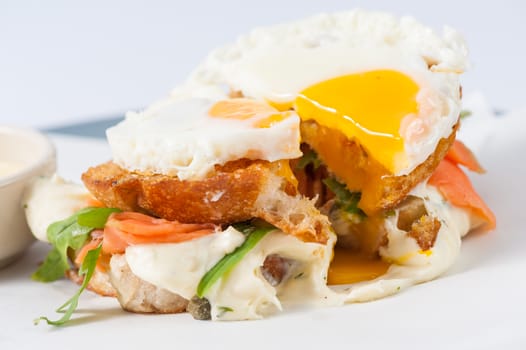 Close up scene of grilled sandwich with bacon and fried egg