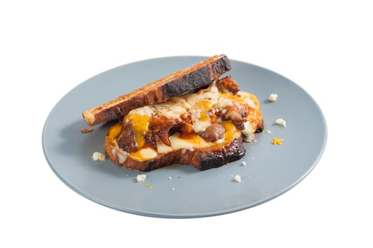 Toasted sandwich with chicken and various types of  cheese in ceramic dish isolated on white background with clipping path.