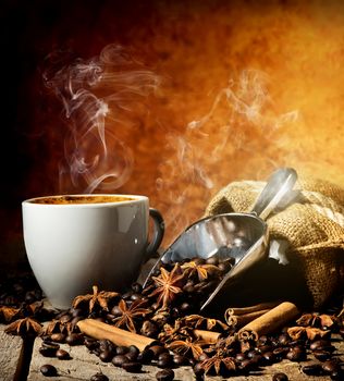 Spices with cup of coffee on a wooden table