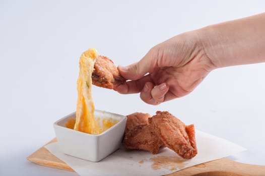 Deep fried chicken wings with various types of cheese for dipping.