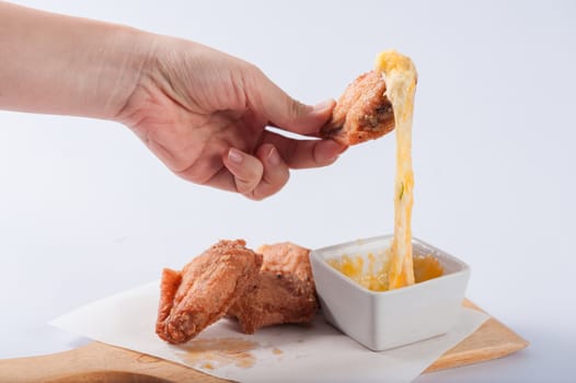 Deep fried chicken wings with various types of cheese for dipping.