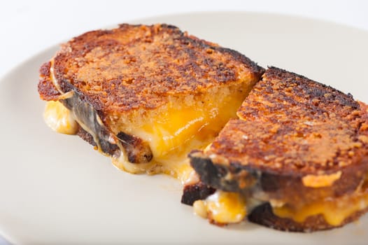 Toasted sandwich with various types of  cheese in ceramic dish