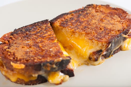 Toasted sandwich with various types of  cheese in ceramic dish