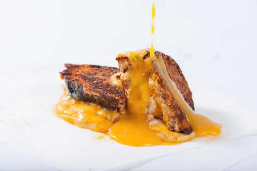 Toasted sandwich with various types of  cheese dressed with mango sauce