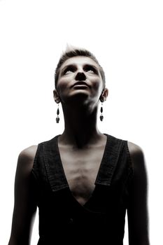 skinny girl with short hair and earrings looking up