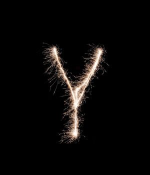 Letter Y drew with spakrs on a black background.