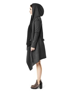 Side view of  woman in black coat. Lookbook photo.