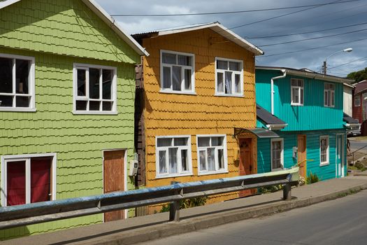 Palafitos viewed from the street. Traditional wooden houses built on stilts along the waters edge in Castro, capital of the Island of Chiloé. These traditional houses are made of wood and usually painted in bright colours.