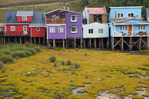 Palafitos. Traditional wooden houses built on stilts along the waters edge in Castro, capital of the Island of Chiloé. These traditional houses are made of wood and usually painted in bright colours.
