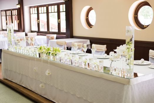 Wedding table decoration with flowers and glassware