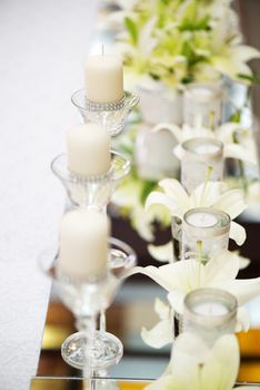 Wedding table decoration with candle, flowers and glassware