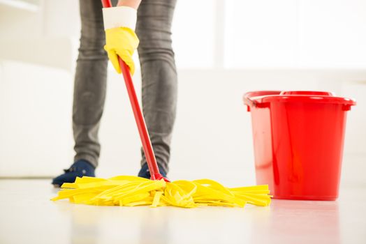 Woman cleaning the house. Close-up with mop.