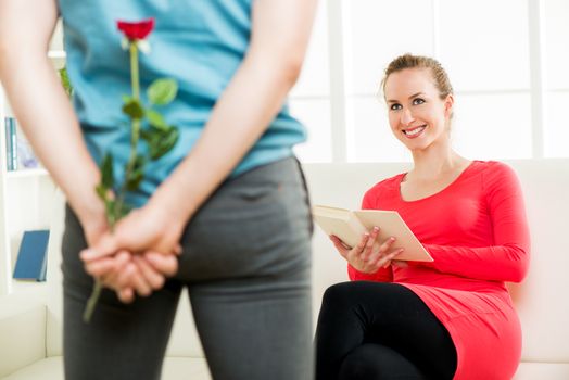 Young boyfriend surprises his beautiful girlfriend with rose