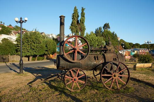 Old steam engine in a coastal garden in Castro, capital of the Island of Chiloe in southern Chile.