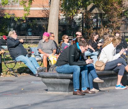 Manhattan, New York - December 06, 2015: Lazy Sunday afternoon in Washington Square Park.