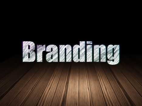 Marketing concept: Glowing text Branding in grunge dark room with Wooden Floor, black background