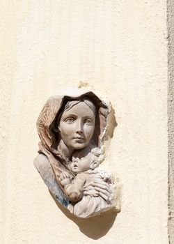 bas-relief of the Virgin and Child on the front wall of building in Malta capital - Valletta, Europe.