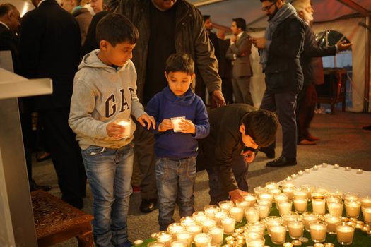 UK, London: Children place candles during a vigil at the Pakistan High Commission in London on March 29, 2016. The gathering honors the victims of the terrorist attack that left at least 72 dead in Lahore, Pakistan on Easter Sunday. Jamaat-ul-Ahrar, a splinter group of the Taliban, claimed responsibility for the attack.