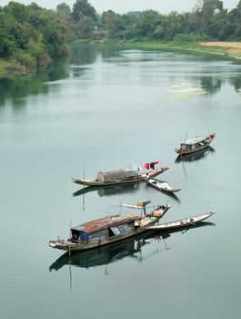 Beautiful landscape at Quang Binh countryside, Viet Nam on day, group of row boat floating on river at fishing village, poor Vietnam people work for live as fisherman and they live on water