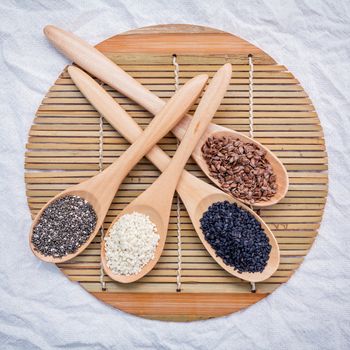 Super healthy of seeds selection  flax seed,chia seed ,black sesame and white sesame in wooden spoon setup on wooden background.