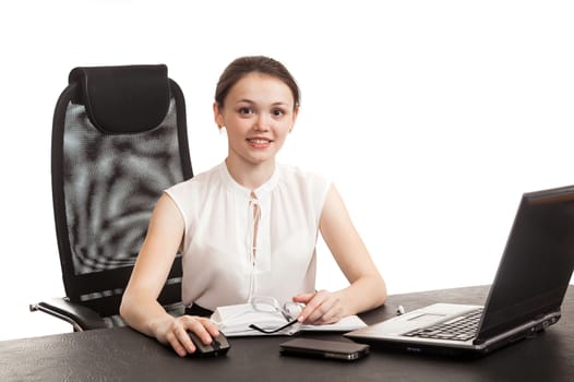 the business woman sits at office table with the laptop