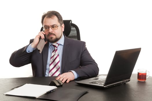 the businessman communicates by phone sitting at a table