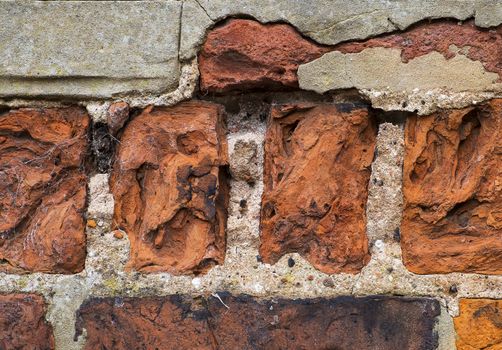 close up of badly weathered bricks with some repairs