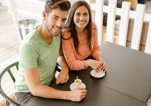 Youg couple at the local coffee shop drinking a coffee