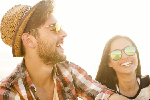 Young couple at the beach and having fun