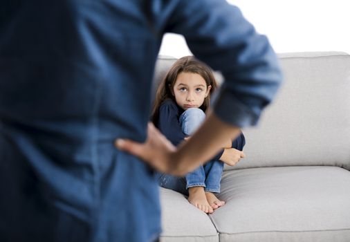 Grown up rebuking a little child for bad behavior