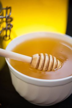 Honey with walnut on wooden background