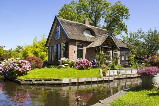 GIETHOORN, NETHERLANDS -typical dutch county side of houses and gardens