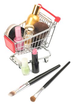 Set of cosmetics tubes in shopping cart with brushes isolated on white background