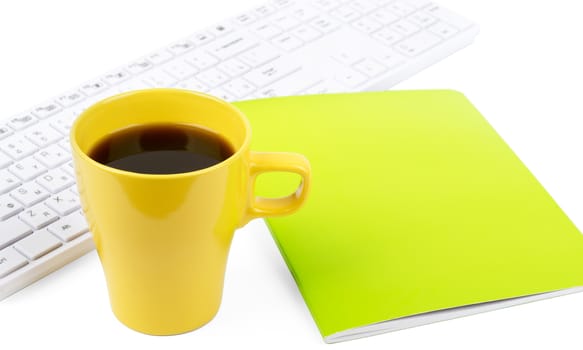 Cup of coffee with keyboard and notebook on isolated white background, closeup