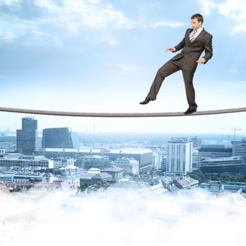 Businessman softly walking on rope above city with closed eyes