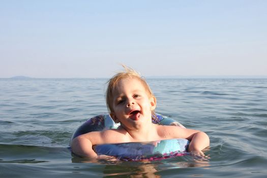 Portrait of cute baby girl enjoying in the sea water