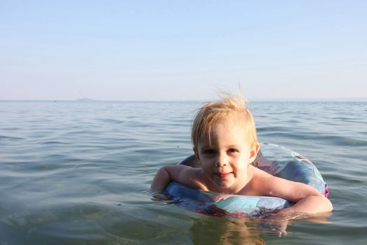Portrait of cute baby girl enjoying in the sea water