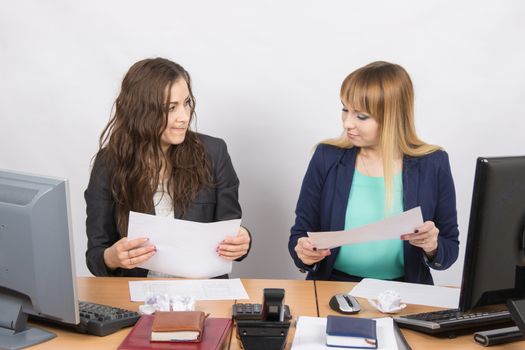 Office colleagues girl at a desk browsing documents