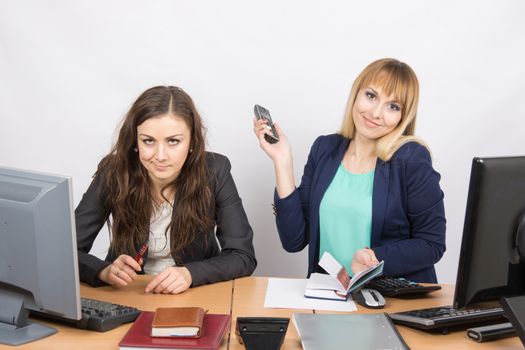 Positive girl in the office with a phone in his hand close to the negative counterpart