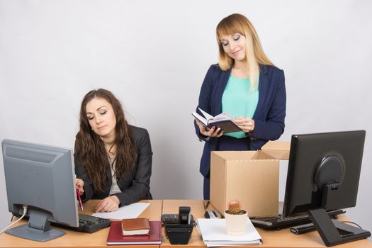 An employee in the office happily lays out things about colleagues