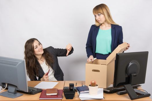 Office gesture girl humiliates the dismissed colleague