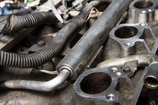 Intake manifold and fuel rail on a car that is being taken apart for repair