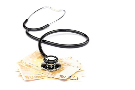 Black professional stethoscope lying on few euro notes isolated on white background