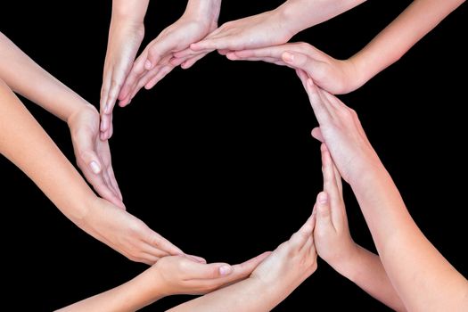 Many arms of young girls with hands making circle isolated on black background