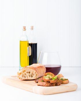 Homemade baguette toasts with olive oil and fresh herbs.