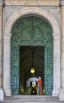 Vatican, Italy - June 26, 2014: Vatican guard stands in front of Vatican Museum in Vatican, Rome, Italy. The Swiss Guards are responsible for the security of Vatican.